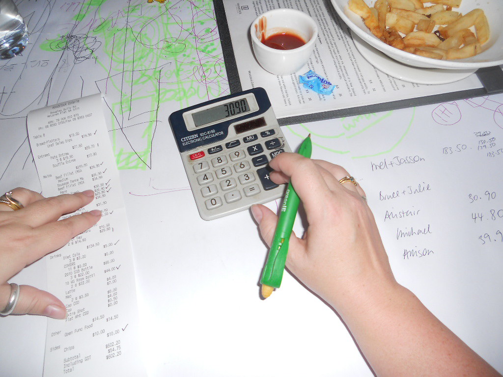 Persona revisando recibos y calculadora para deducir IVA soportado